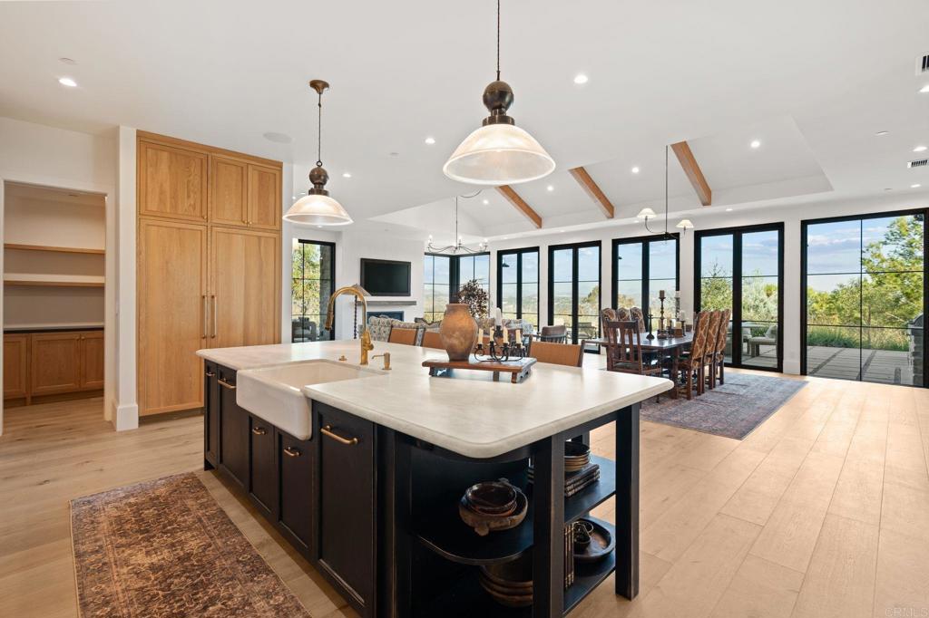 15816 Via Del Alba Rancho Santa Fe, CA 92067 - Photo 11 of 50 a large kitchen with a table and chairs