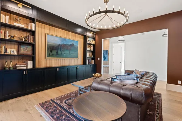 a living room with furniture and a chandelier