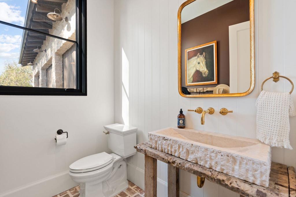 15816 Via Del Alba Rancho Santa Fe, CA 92067 - Photo 20 of 50 a bathroom with a toilet sink and mirror