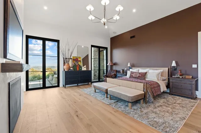 a bedroom with a bed and a lamp on dresser