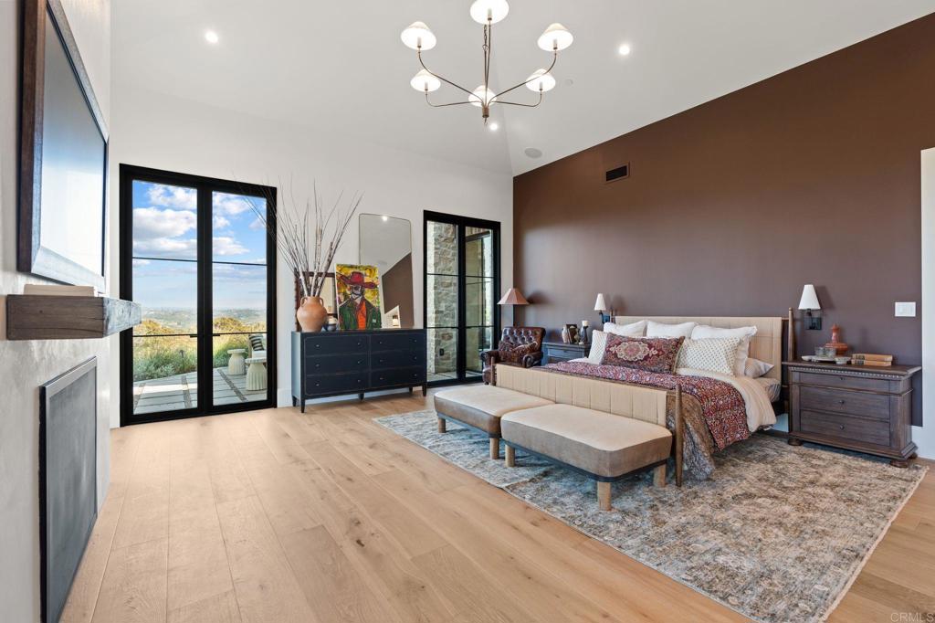 15816 Via Del Alba Rancho Santa Fe, CA 92067 - Photo 21 of 50 a spacious bedroom with a large bed and a chandelier