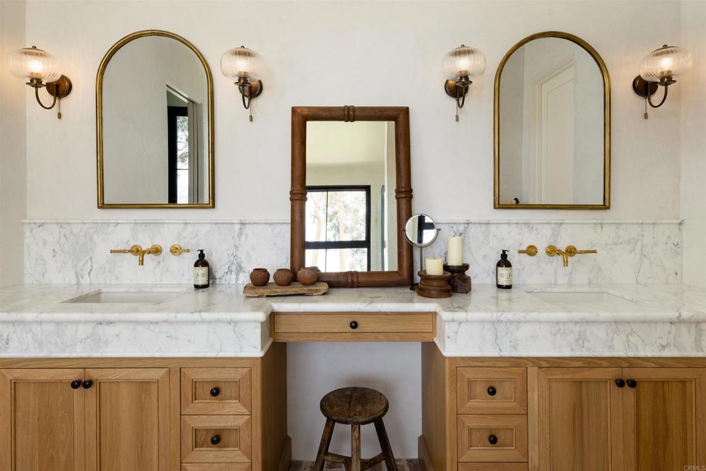 15816 Via Del Alba Rancho Santa Fe, CA 92067 - Photo 26 of 50 a bathroom with a granite countertop sink a mirror and cabinets