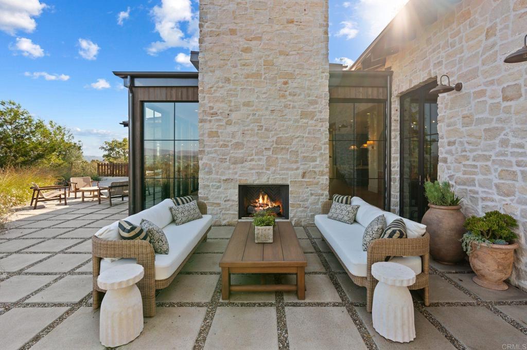 15816 Via Del Alba Rancho Santa Fe, CA 92067 - Photo 30 of 50 a outdoor space with patio the couches and a fireplace with the potted plants