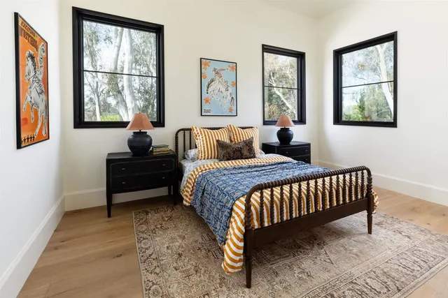 a bedroom with two beds and a large window