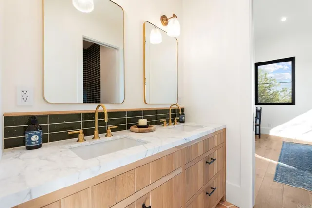 a bathroom with a sink a mirror and vanity