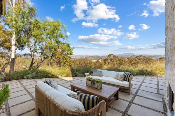 a living room with fireplace furniture and a floor to ceiling window