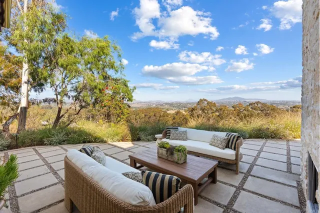 a living room with fireplace furniture and a floor to ceiling window