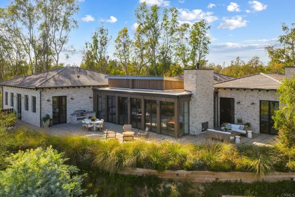 a view of swimming pool with outdoor seating and plants