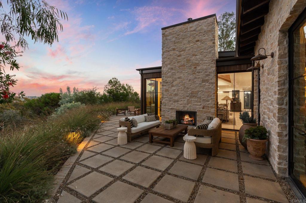 15816 Via Del Alba Rancho Santa Fe, CA 92067 - Photo 44 of 50 a view of a patio with couches and table and chairs with wooden floor and fence