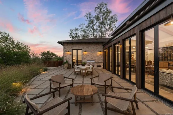 a view of house with yard and outdoor seating