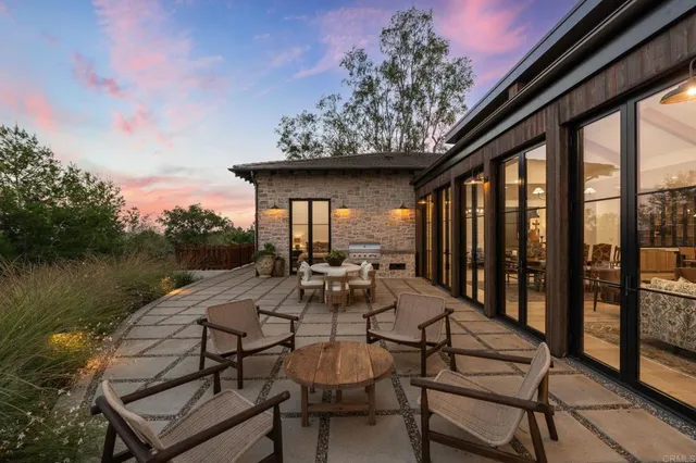 a view of house with yard and outdoor seating