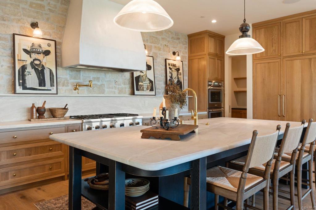15816 Via Del Alba Rancho Santa Fe, CA 92067 - Photo 6 of 50 a kitchen with a table and chairs in it