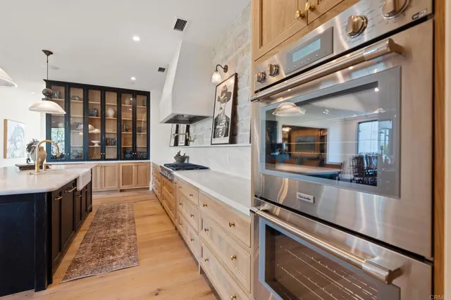 a large kitchen with a table and chairs