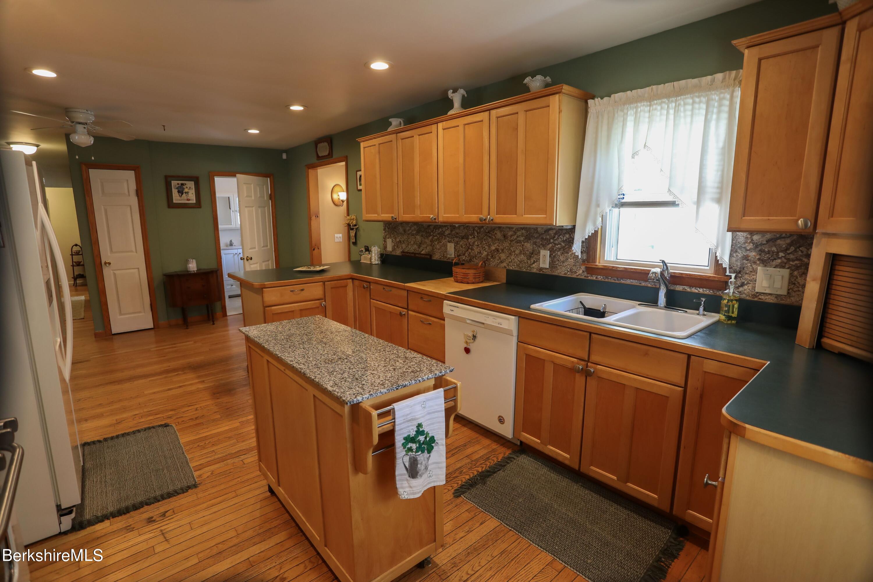 792 Middle Road Clarksburg, MA 01247 - Photo 11 of 40 a kitchen with a sink stove and cabinets