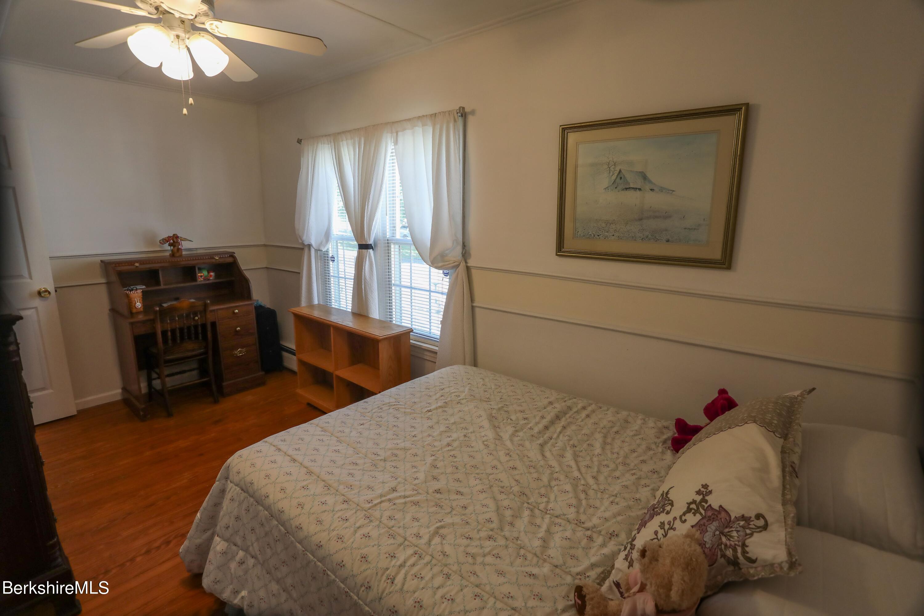792 Middle Road Clarksburg, MA 01247 - Photo 14 of 40 a bedroom with a bed and a chandelier