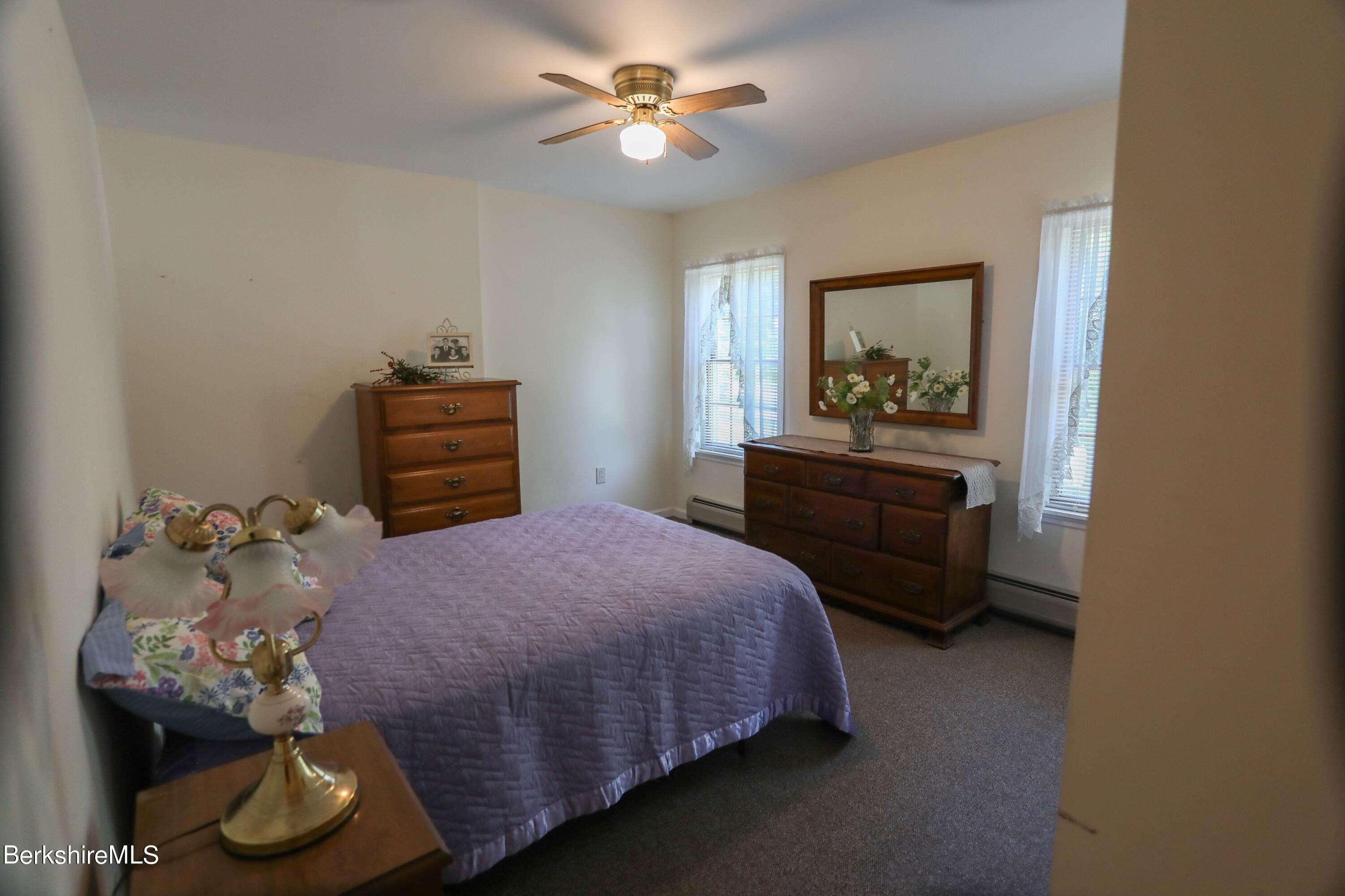 792 Middle Road Clarksburg, MA 01247 - Photo 15 of 40 a bedroom with a bed and a chandelier