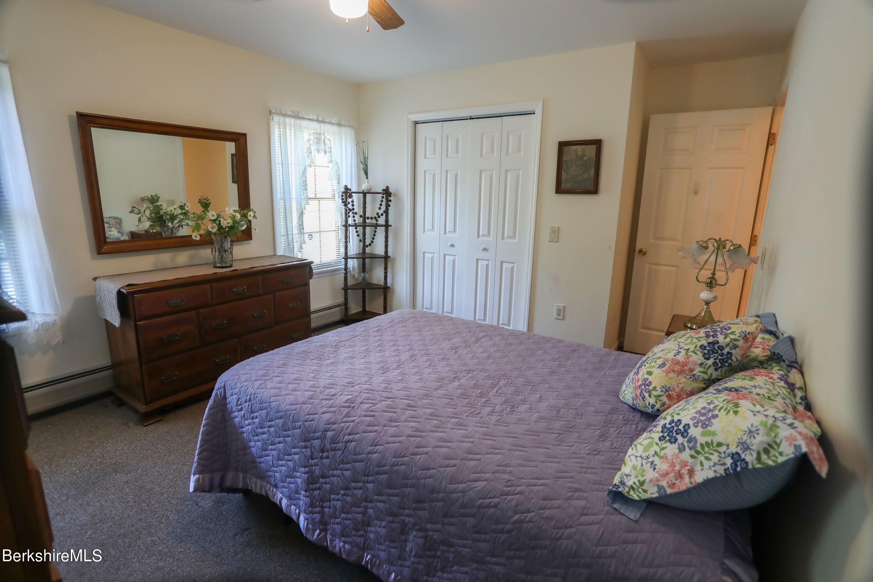 792 Middle Road Clarksburg, MA 01247 - Photo 16 of 40 a bedroom with a bed and a mirror on dresser