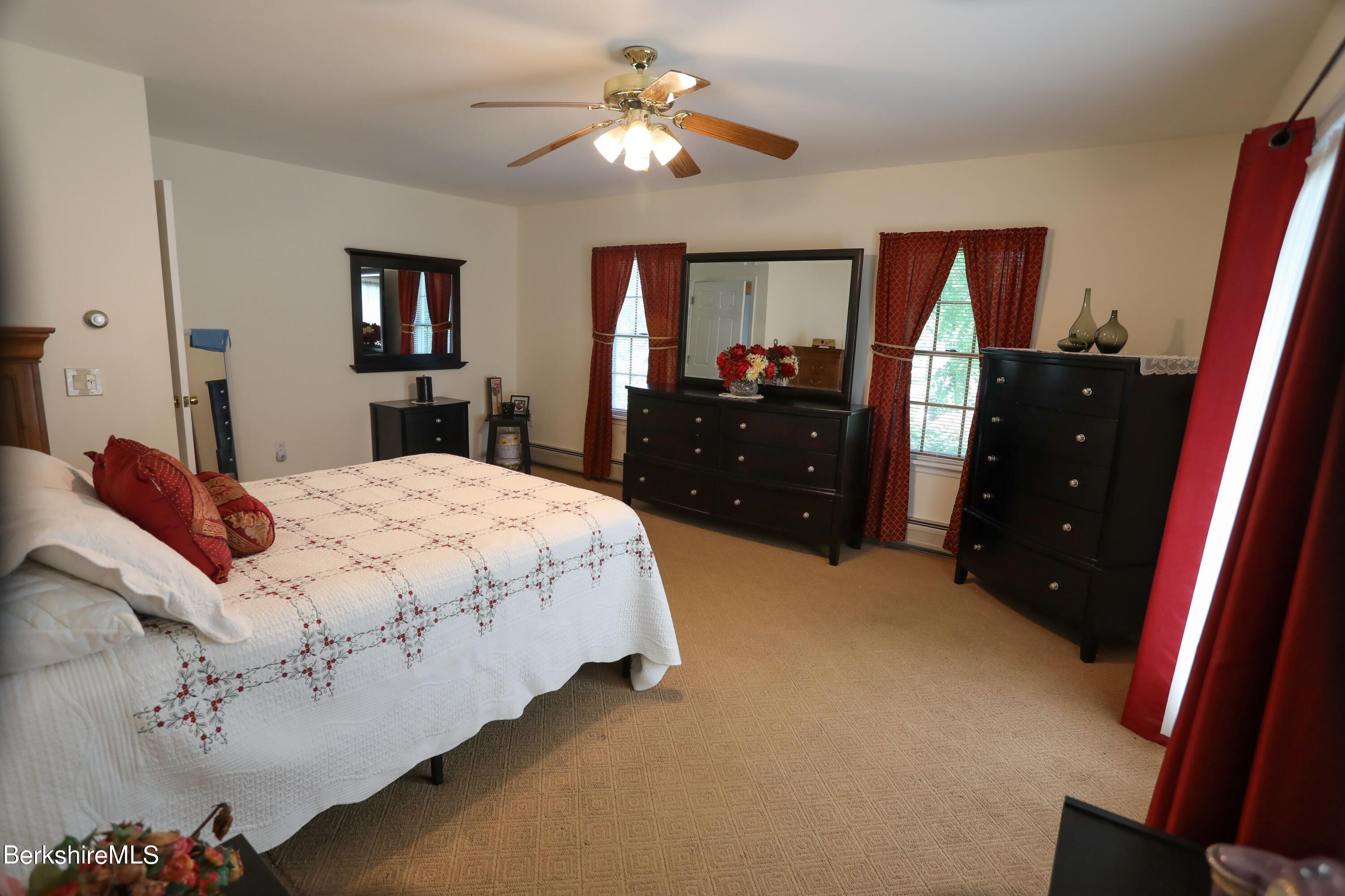 792 Middle Road Clarksburg, MA 01247 - Photo 21 of 40 a bedroom with a bed and a mirror on dresser