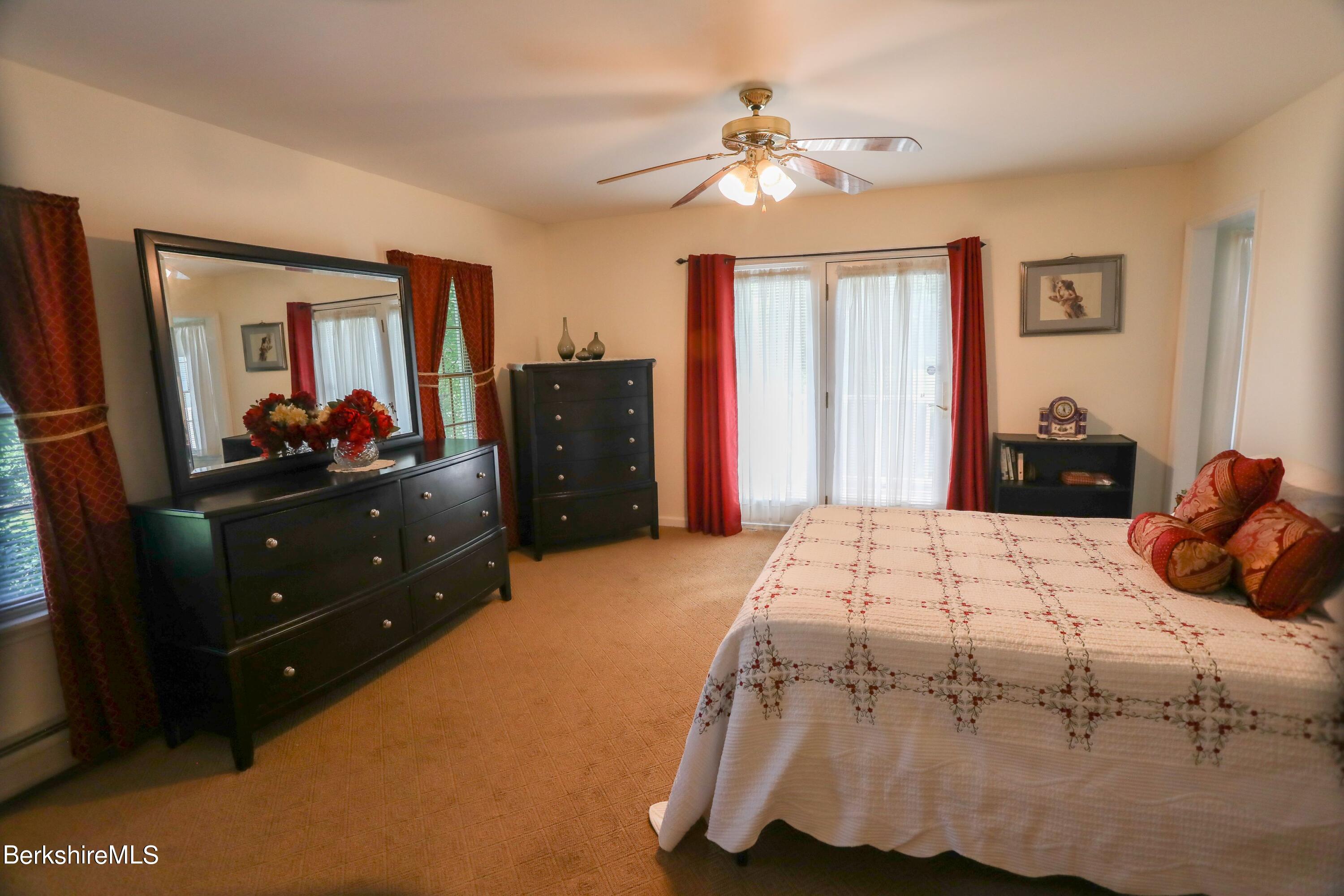 792 Middle Road Clarksburg, MA 01247 - Photo 22 of 40 a bedroom with a bed and a chandelier