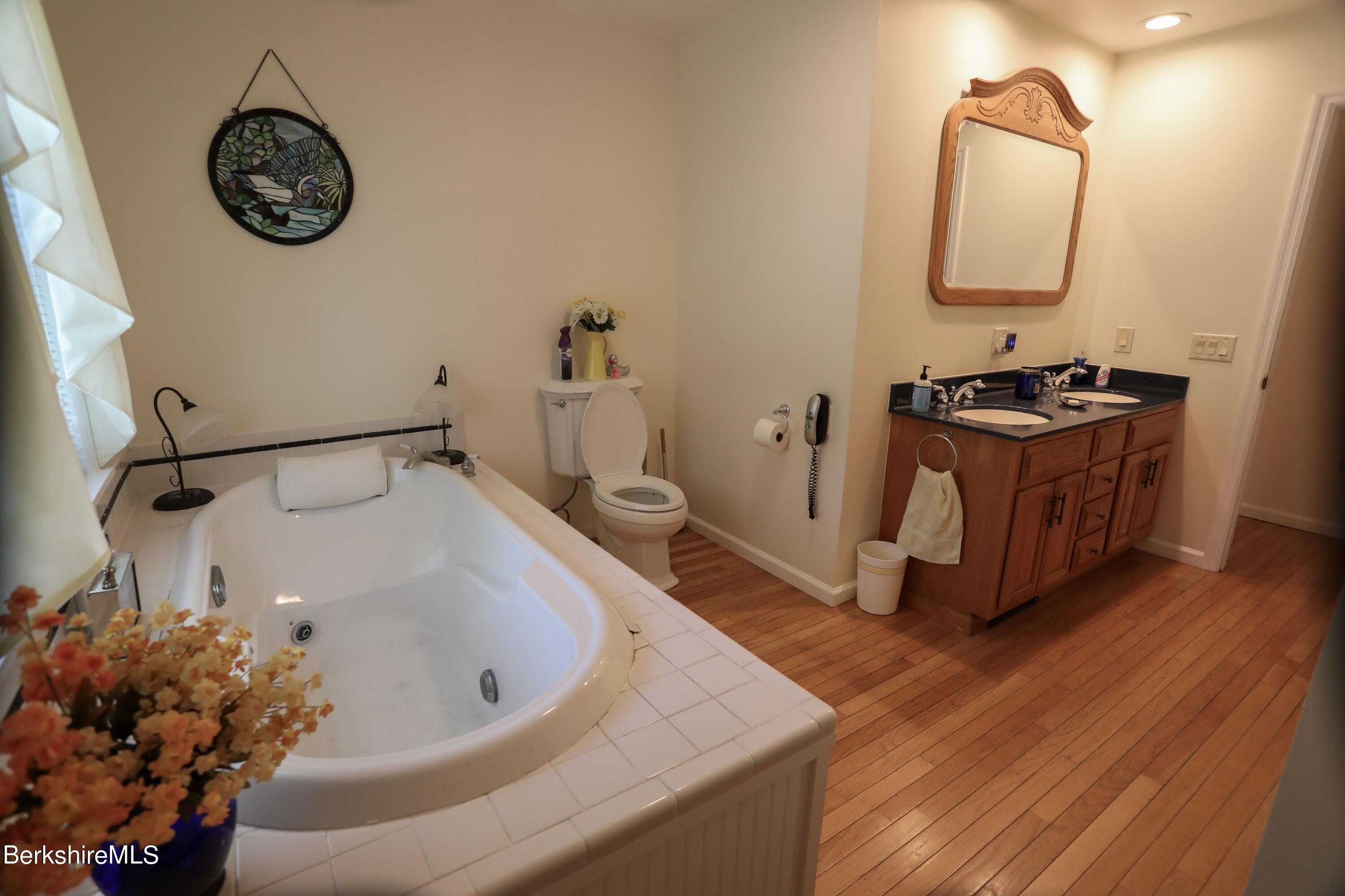 792 Middle Road Clarksburg, MA 01247 - Photo 25 of 40 a bathroom with a tub sink and mirror