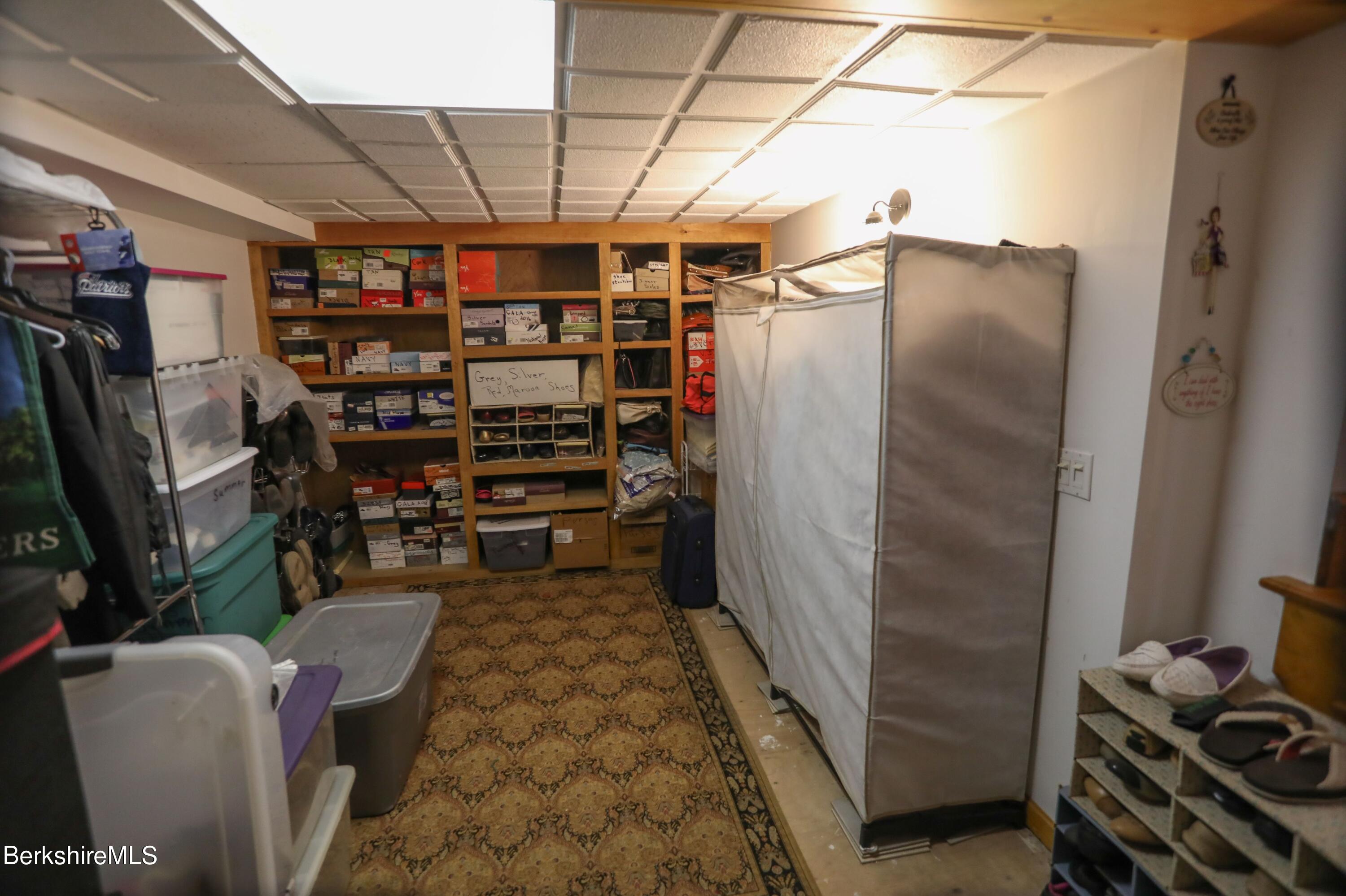 792 Middle Road Clarksburg, MA 01247 - Photo 32 of 40 a view of store room with water heater and racks