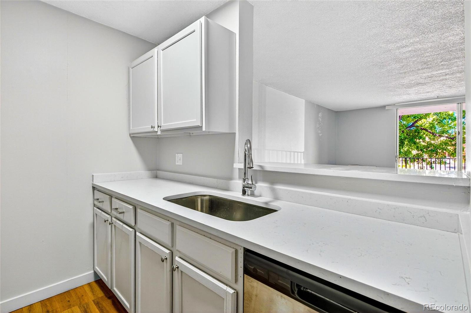 2281 South Vaughn Way Aurora, CO 80014 - Photo 11 of 23 a kitchen with a sink and a window
