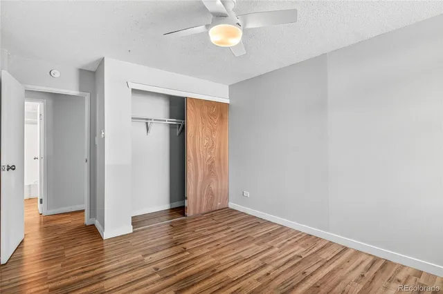 a view of empty room with wooden floor