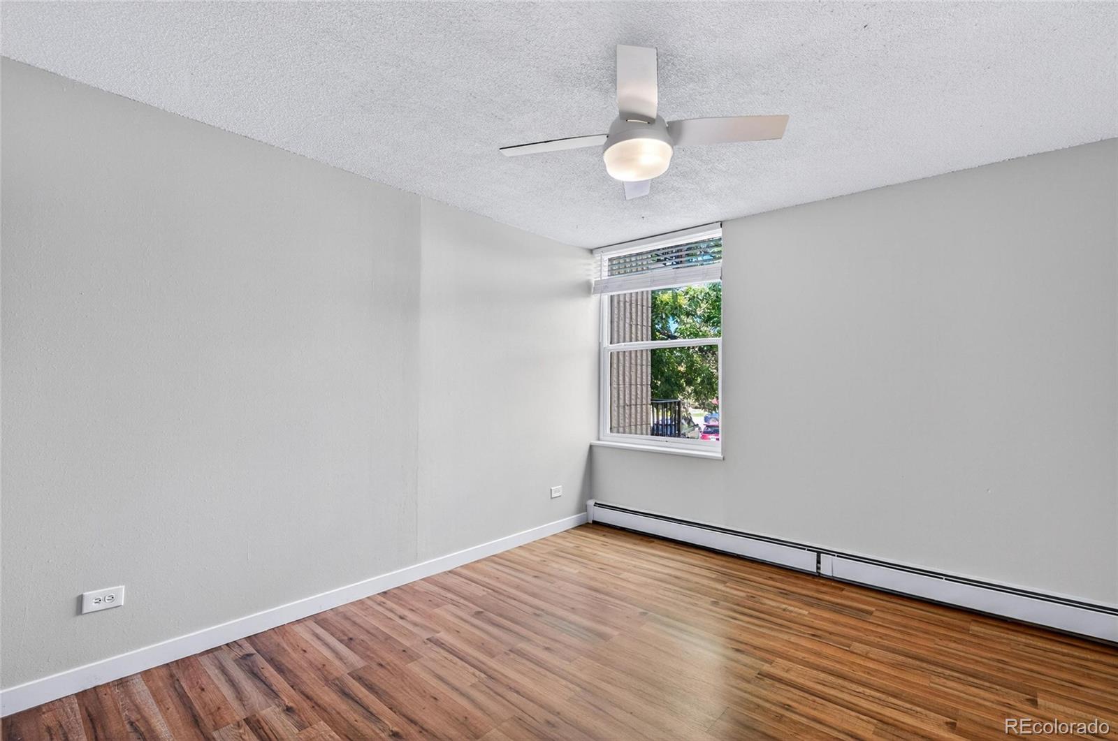 2281 South Vaughn Way Aurora, CO 80014 - Photo 14 of 23 wooden floor in an empty room with a window