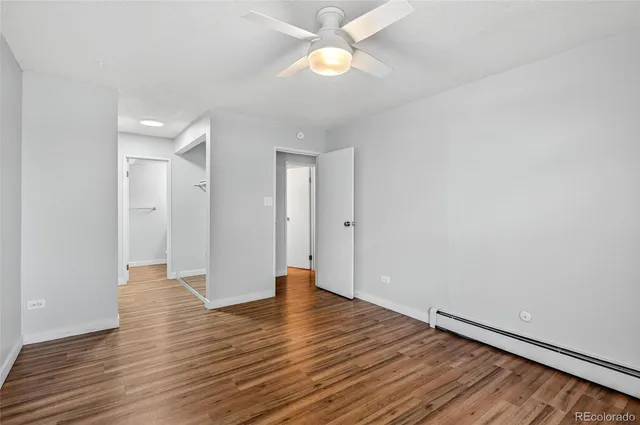 a view of an empty room with wooden floor
