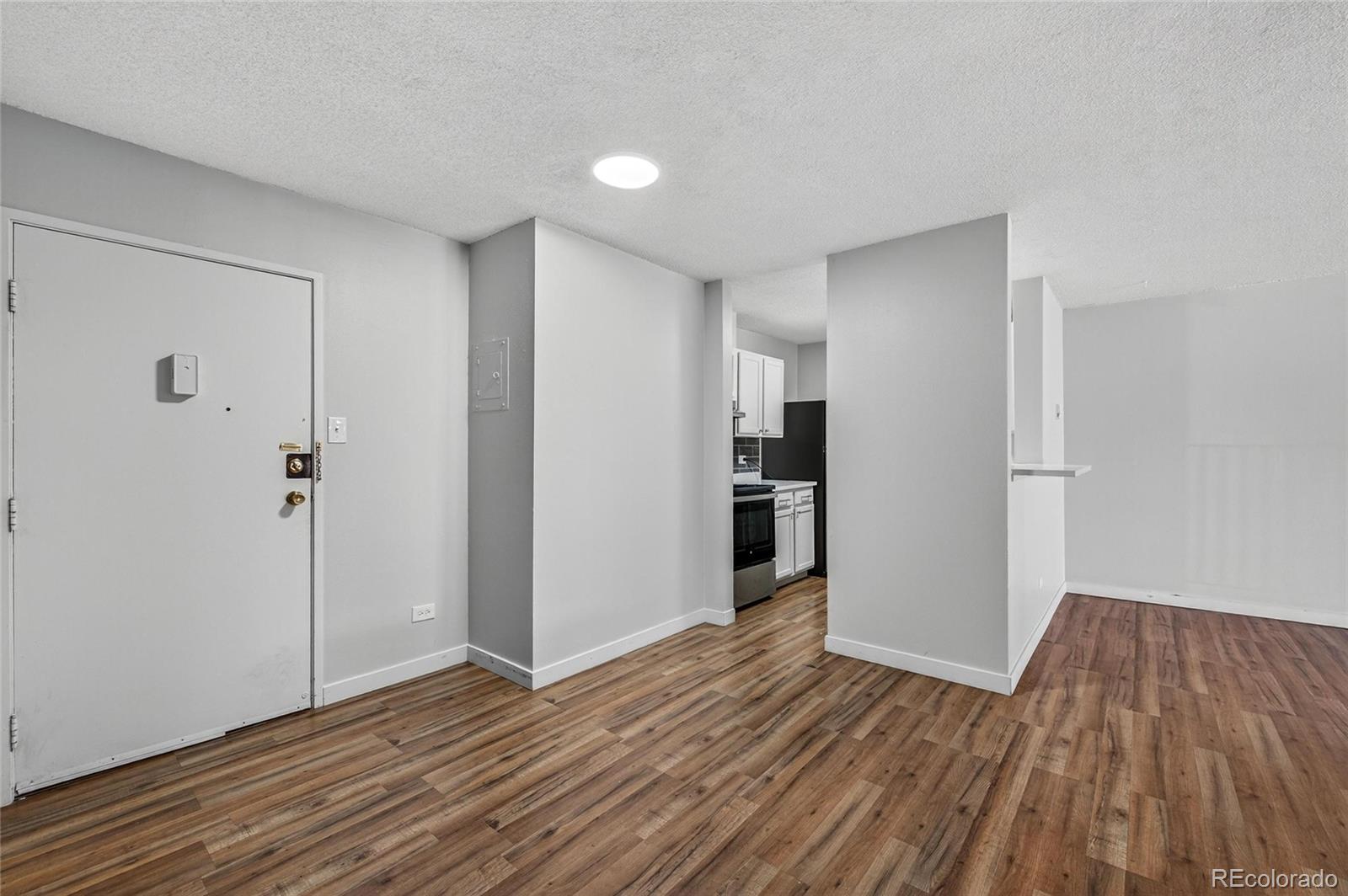 2281 South Vaughn Way Aurora, CO 80014 - Photo 2 of 23 a view of empty room with wooden floor