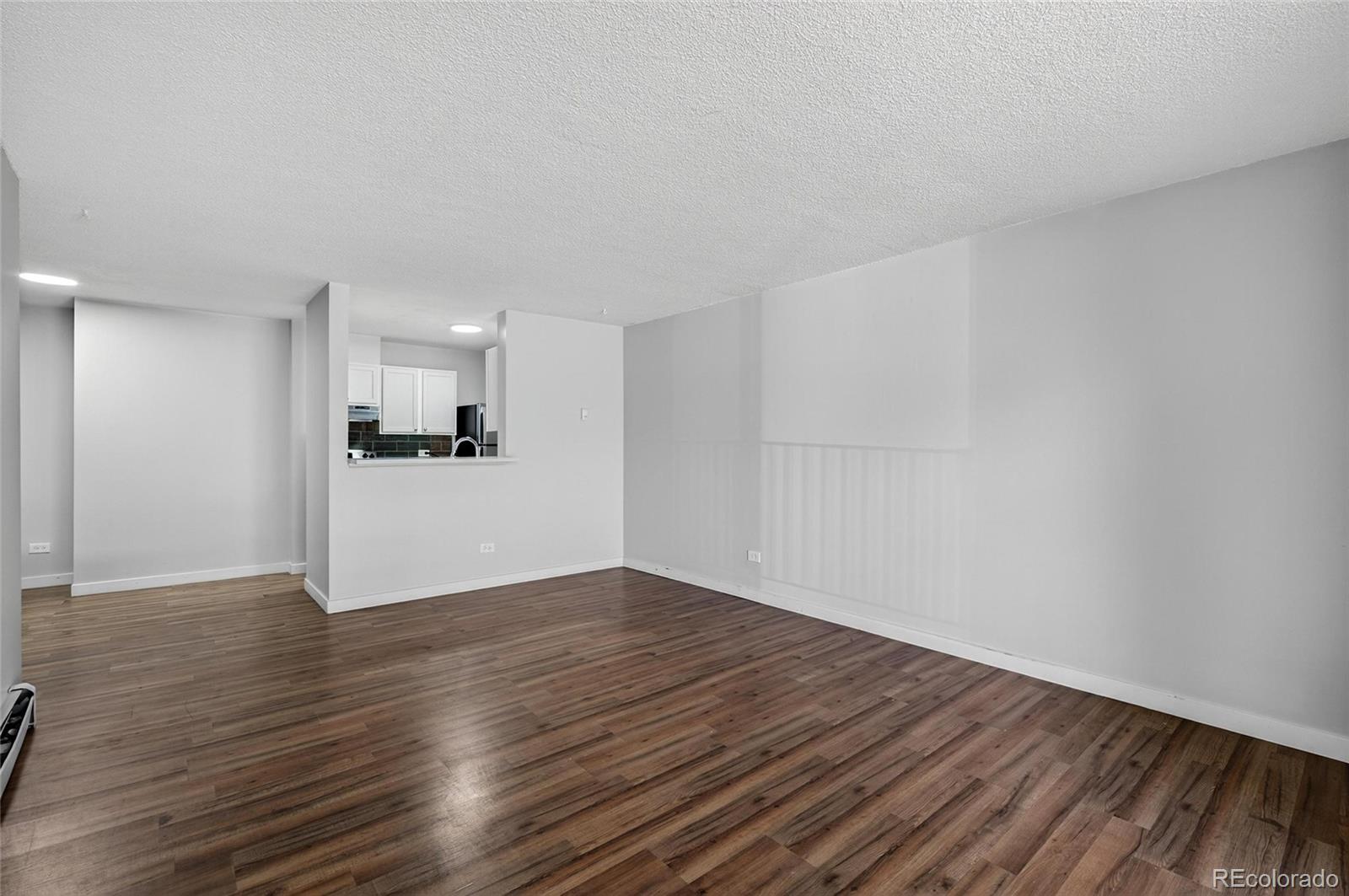 2281 South Vaughn Way Aurora, CO 80014 - Photo 3 of 23 a view of empty room with wooden floor