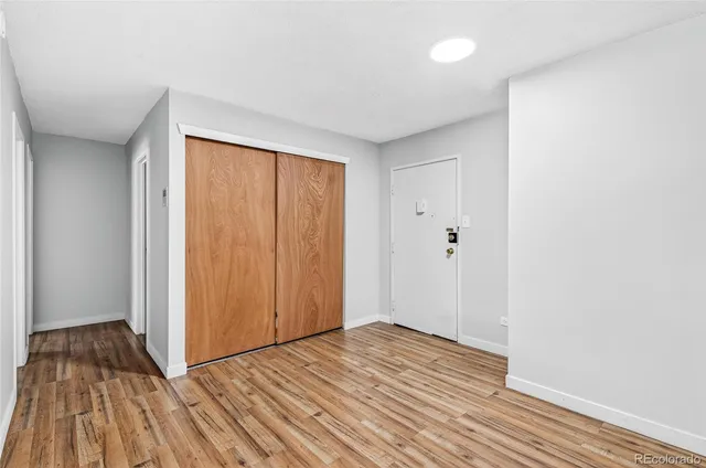 a view of a room with wooden floor