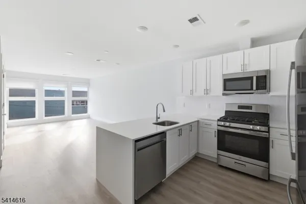 a kitchen with a stove top oven and sink