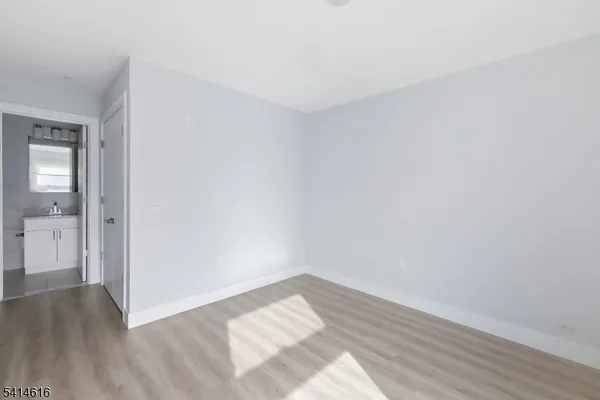 a view of an empty room and wooden floor