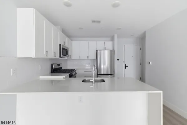 a kitchen with stainless steel appliances a refrigerator and a stove