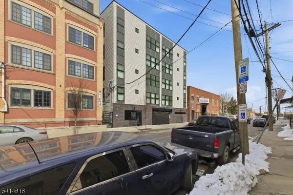 a view of a building with cars parked