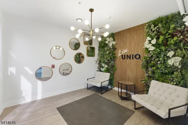 a living room with couches and a chandelier