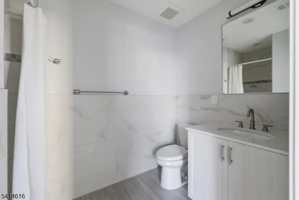 a white toilet sitting next to a bathroom sink