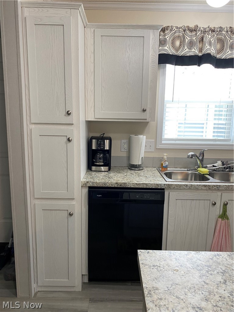 2700 Brookpark Road, Unit 626 Cleveland, OH 44134 - Photo 5 of 32 Kitchen with white cabinetry, dishwashing machine, and sink