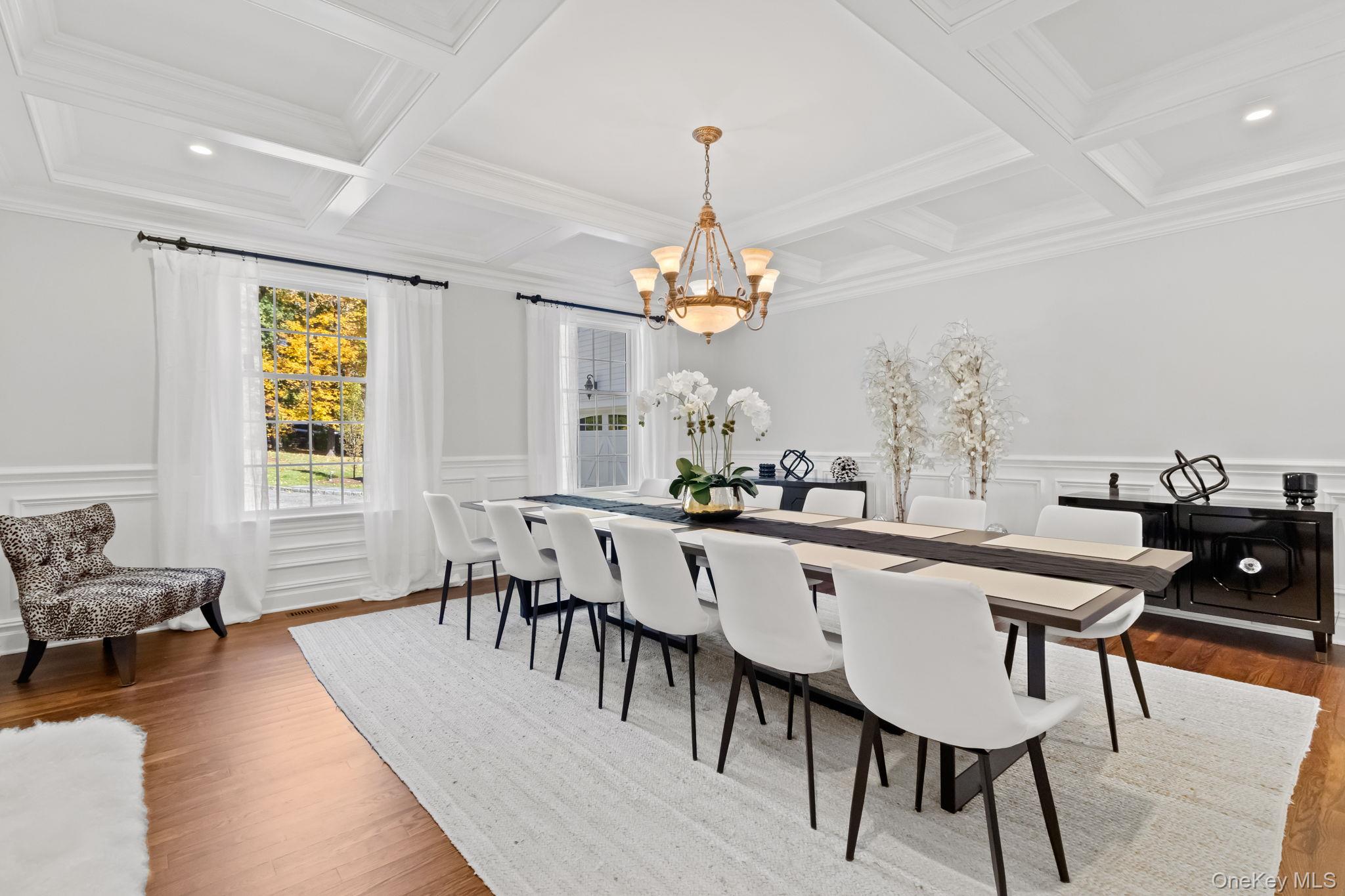 496 Long Ridge Road Bedford, NY 10576 - Photo 10 of 49 Dining space featuring a decorative wall, beam ceiling, a wainscoted wall, a chandelier, and wood finished floors