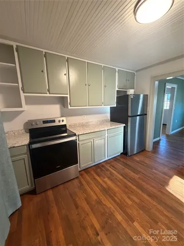 a kitchen with a sink appliances and cabinets