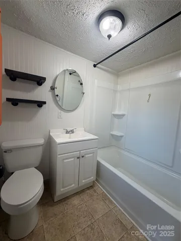 a bathroom with a sink a toilet and a bathtub