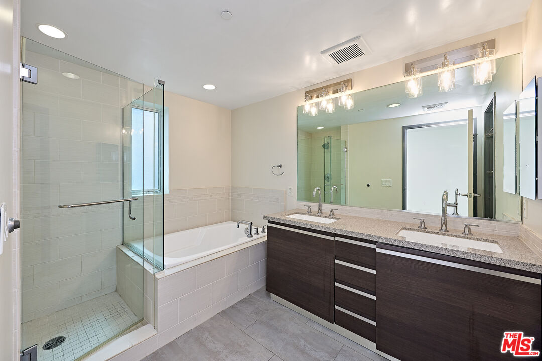 3119 Vía Dolce, Unit 302 Marina del Rey, CA 90292 - Photo 11 of 27 a bathroom with a granite countertop sink mirror and a bathtub
