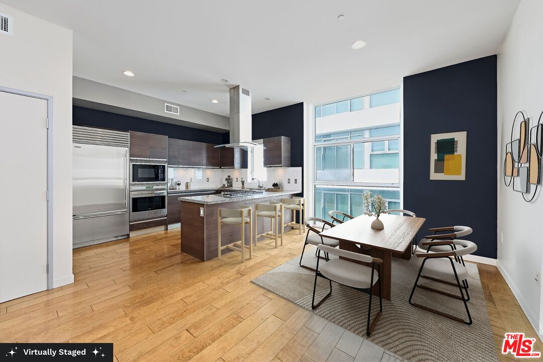 3119 Vía Dolce, Unit 302 Marina del Rey, CA 90292 - Photo 2 of 27 a open kitchen with a table chairs refrigerator and cabinets