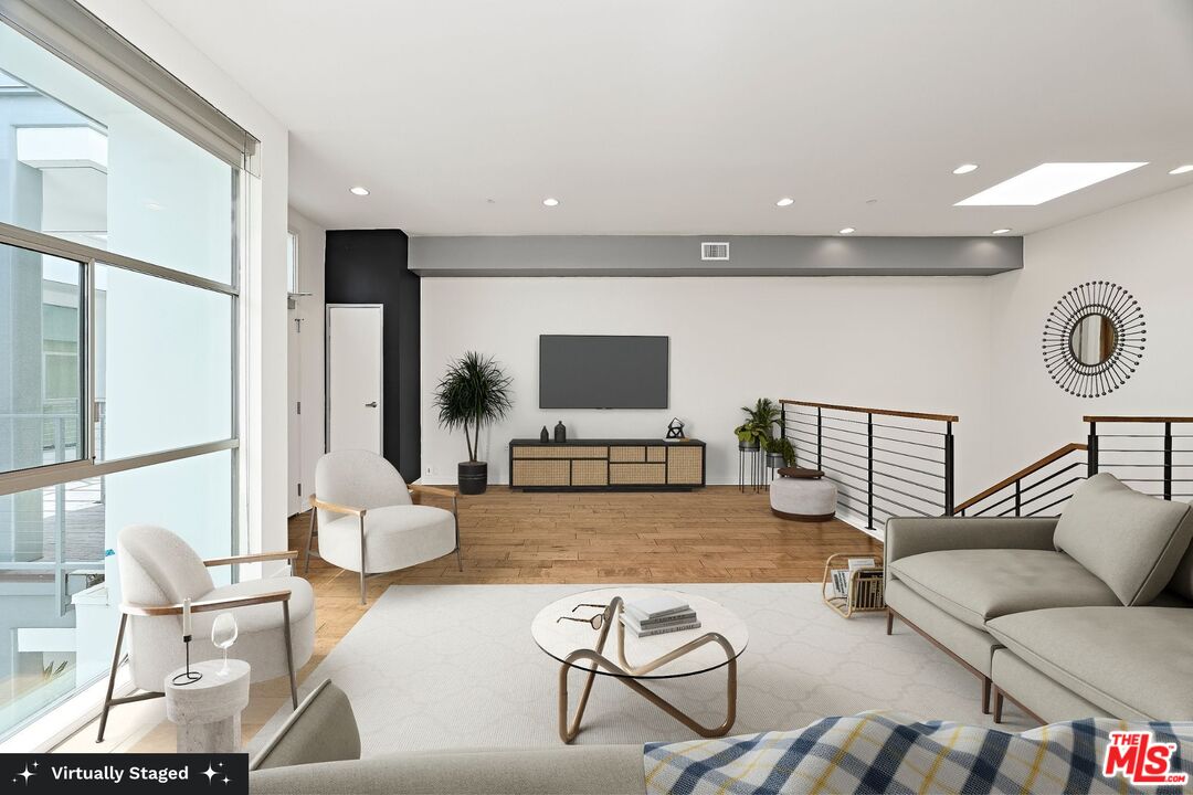 3119 Vía Dolce, Unit 302 Marina del Rey, CA 90292 - Photo 6 of 27 a living room with furniture and a flat screen tv