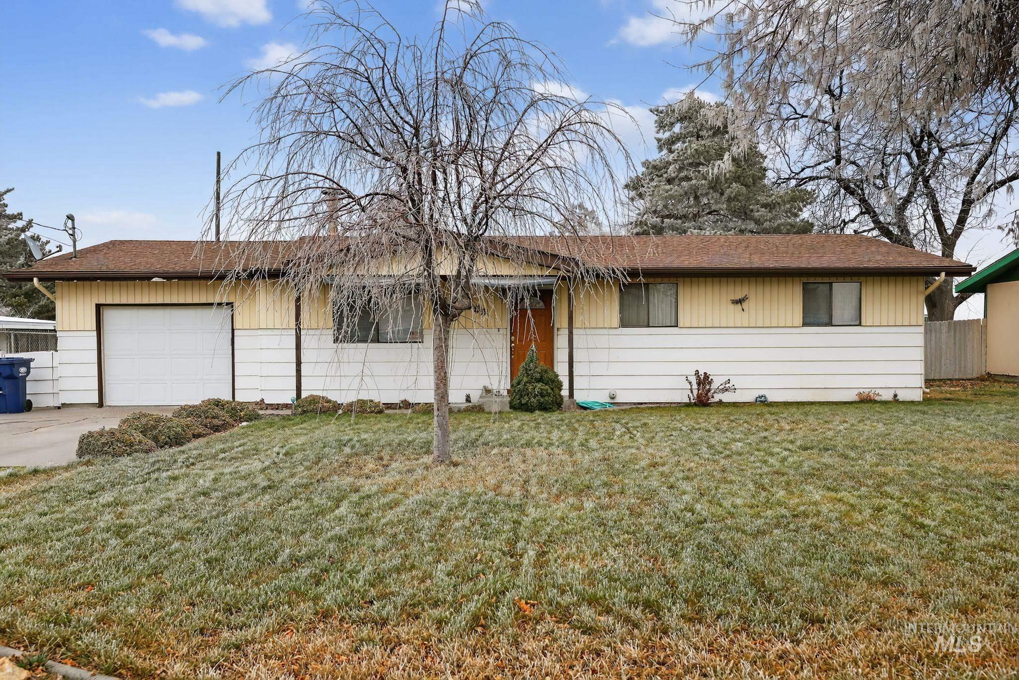 Ranch-style home featuring concrete driveway, a garage, and roof with shingles