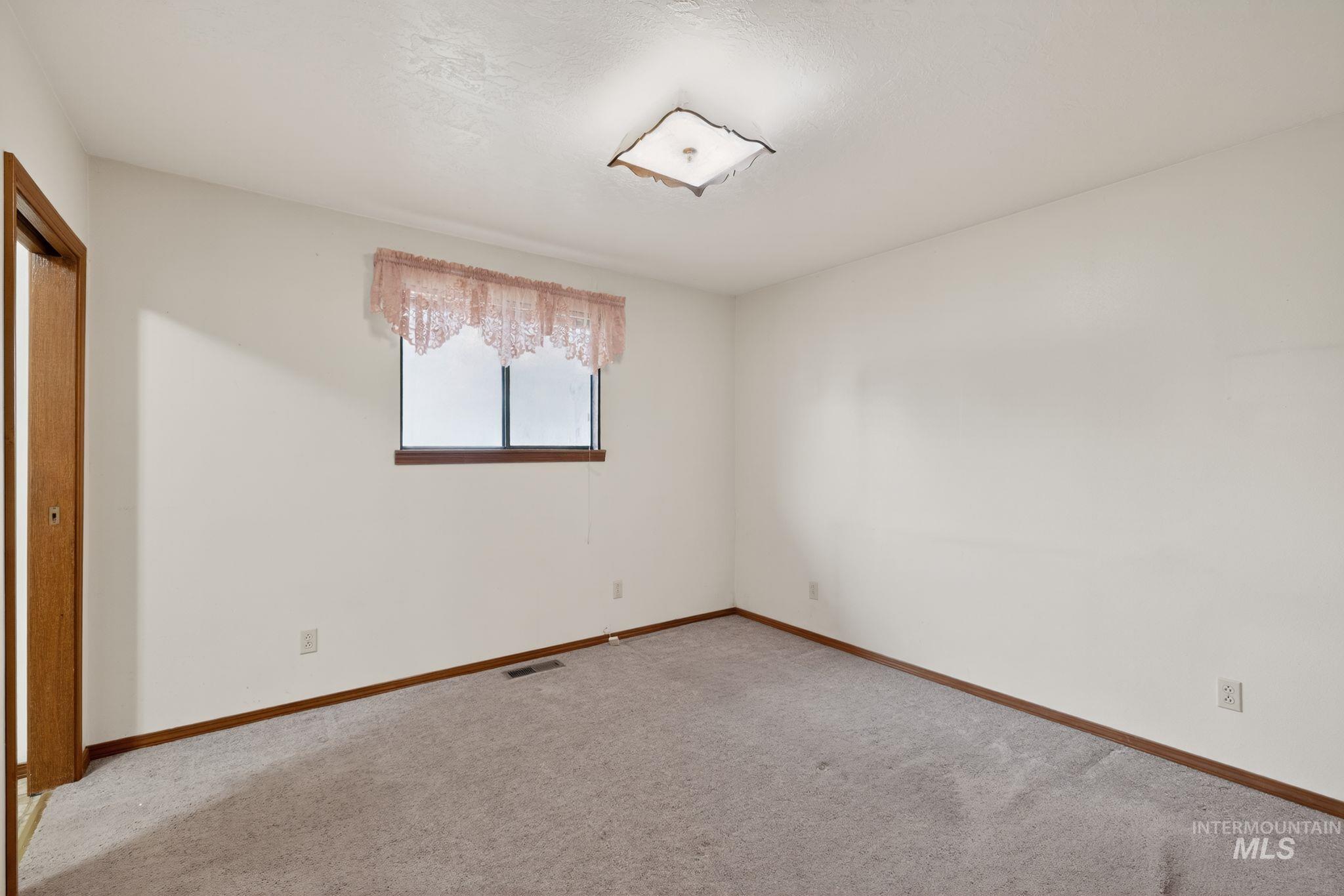 1055 South Adell Street Filer, ID 83328 - Photo 20 of 28 Unfurnished bedroom featuring carpet flooring and baseboards