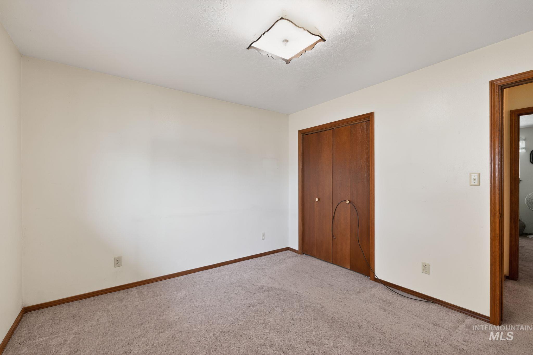 1055 South Adell Street Filer, ID 83328 - Photo 22 of 28 Unfurnished bedroom featuring a closet and carpet flooring