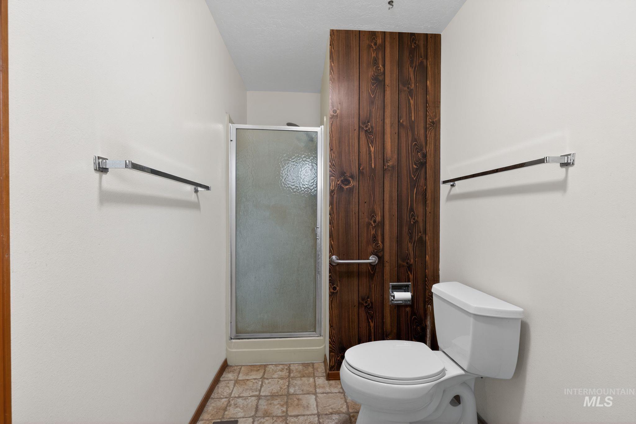 1055 South Adell Street Filer, ID 83328 - Photo 24 of 28 Full bath featuring a shower stall and stone finish floors