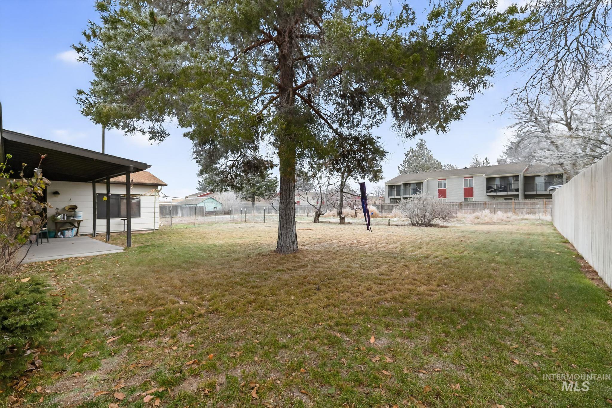 1055 South Adell Street Filer, ID 83328 - Photo 6 of 28 Fenced backyard with a patio area